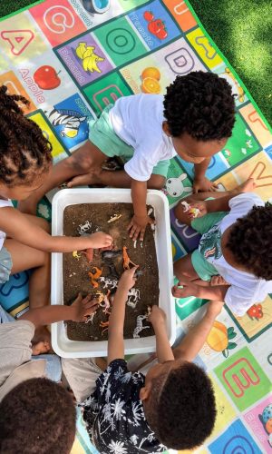 Wonderwell - Children playing with toys and sand in a safe place