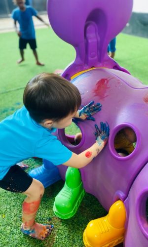 Wonderwell - Child playing with paint outside
